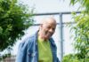 United to Help Neighbors Fulfill Their Potential An older man waters his garden outside.