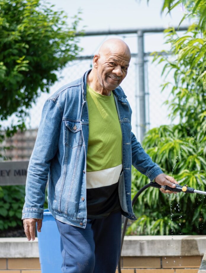 United Way of Southwestern Pennsylvania An older man waters his garden outside.