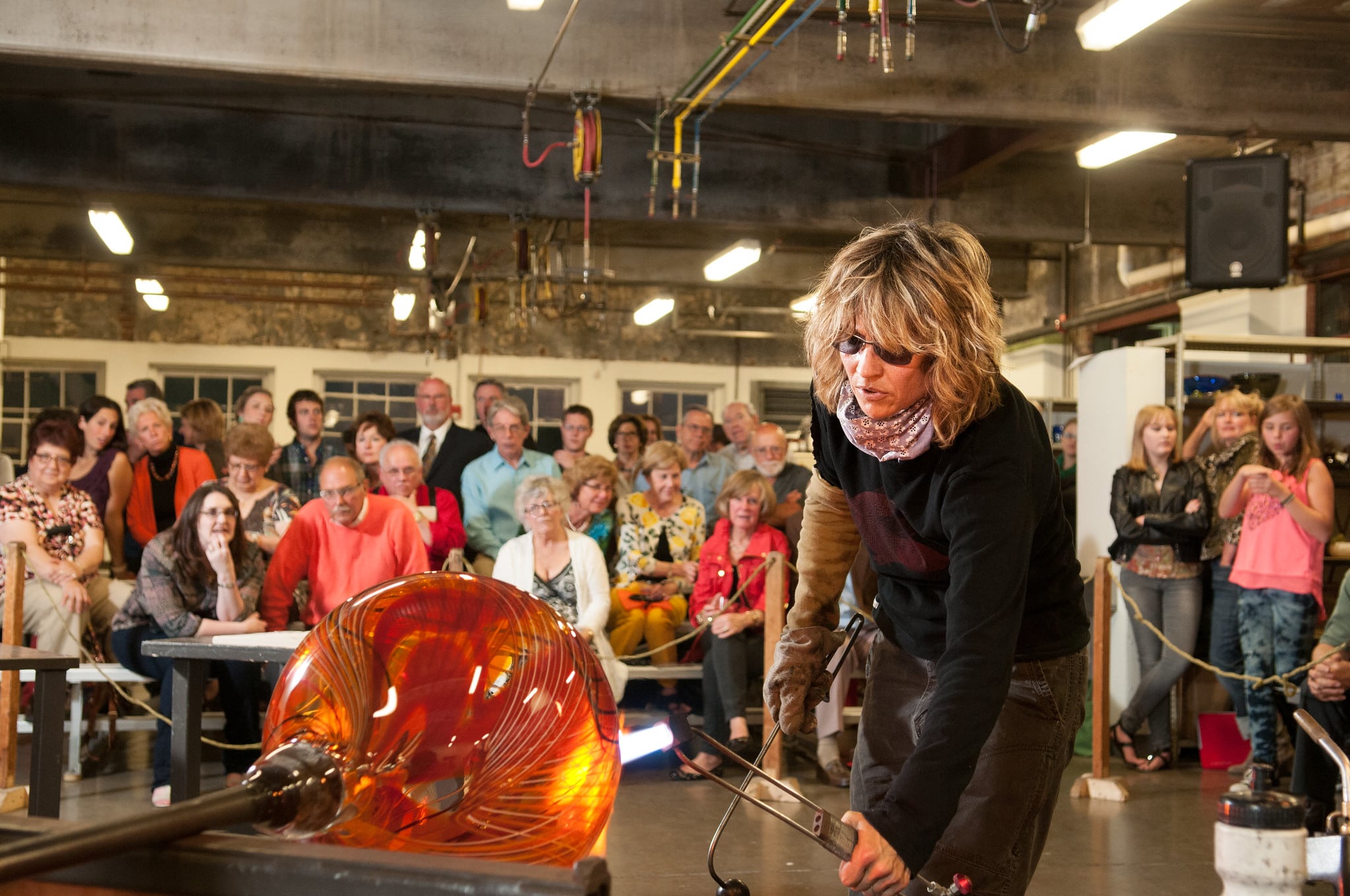 HOT Jam – 25 Years and Still Glowing! people watching a woman blow glass
