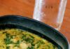 Chicken and Orzo Soup with Rotisserie Chicken A black bowl of Chicken and Orzo Soup with a silver ladle in it.