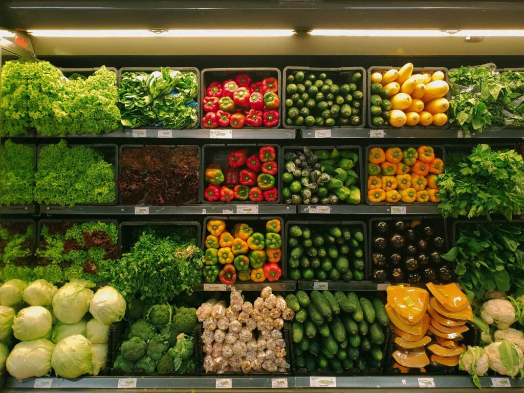 Shelves of vegetable produce inside a grocery store. 