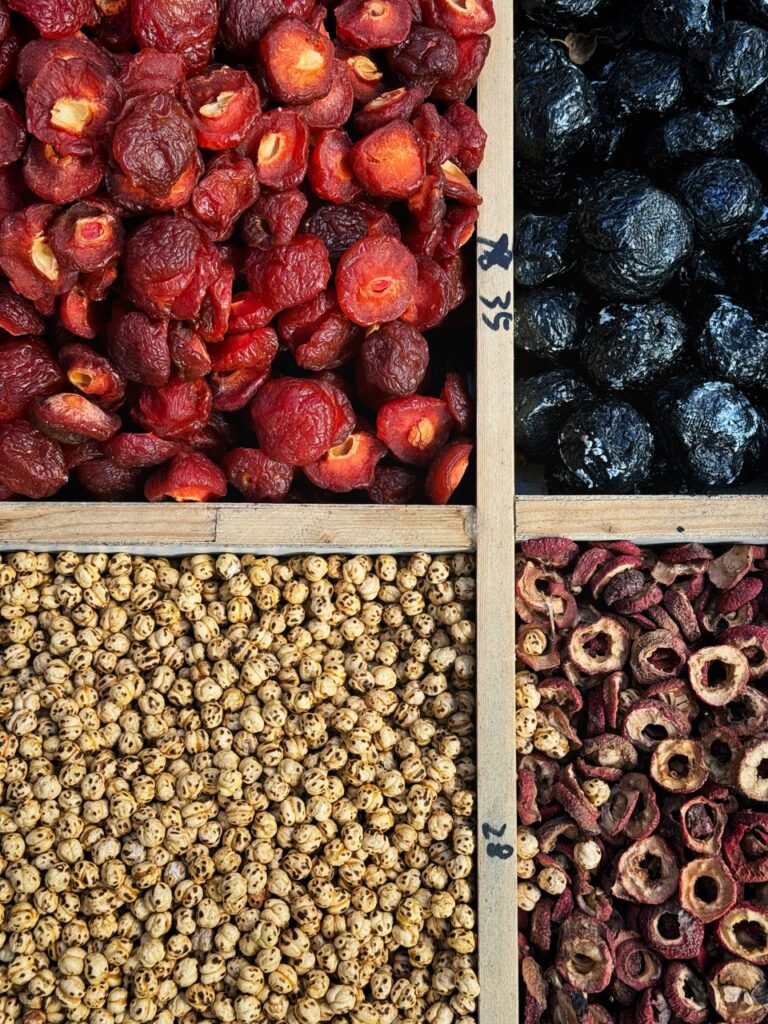 Four sections of berries, nuts, and seeds.