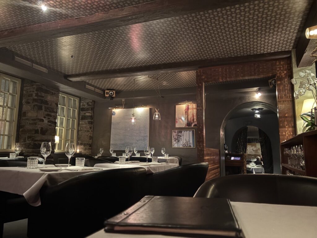 A sleek modern dining room in dark brown colors.