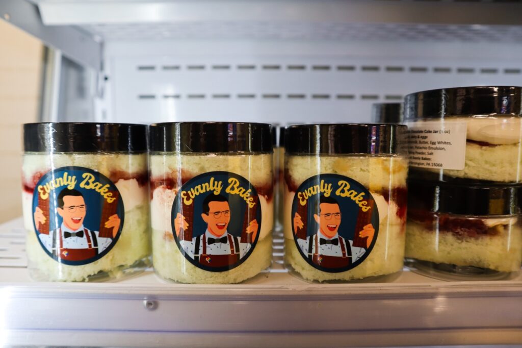 Three cake jars sit on a shelf.