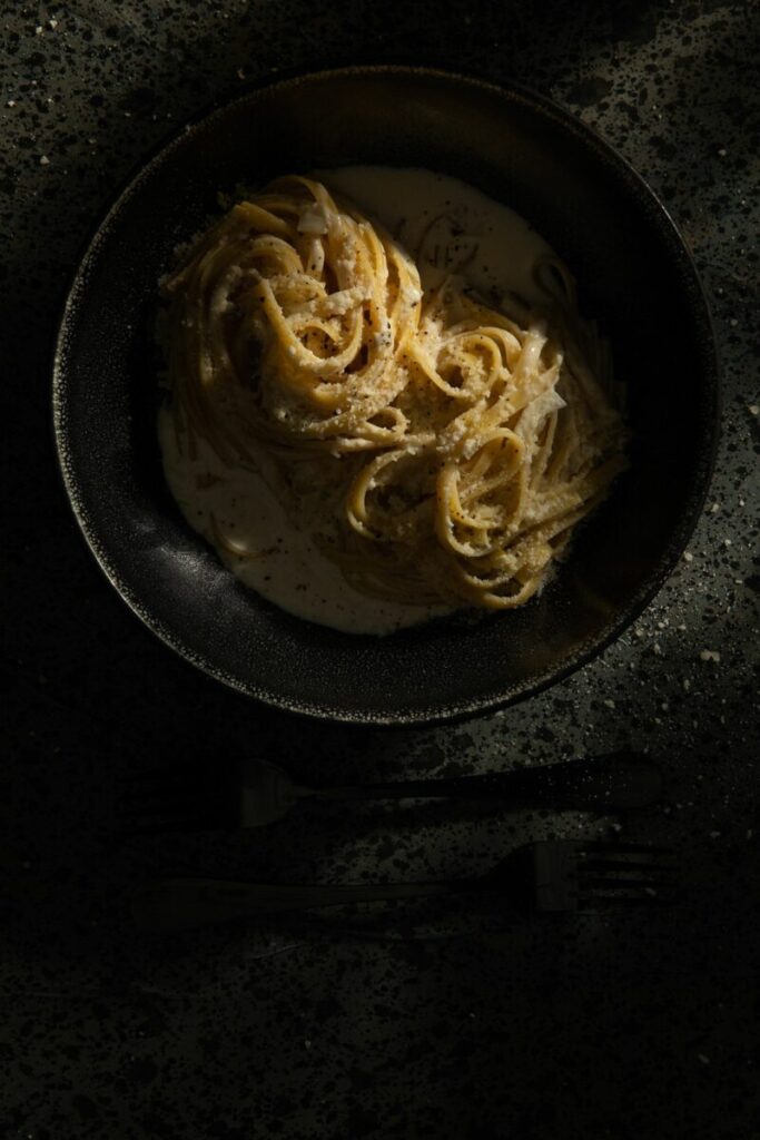 A black dish filled with Fettucine Aldredo made by Victoria Sande.