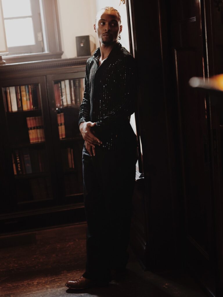 A man in all black dress clothes.