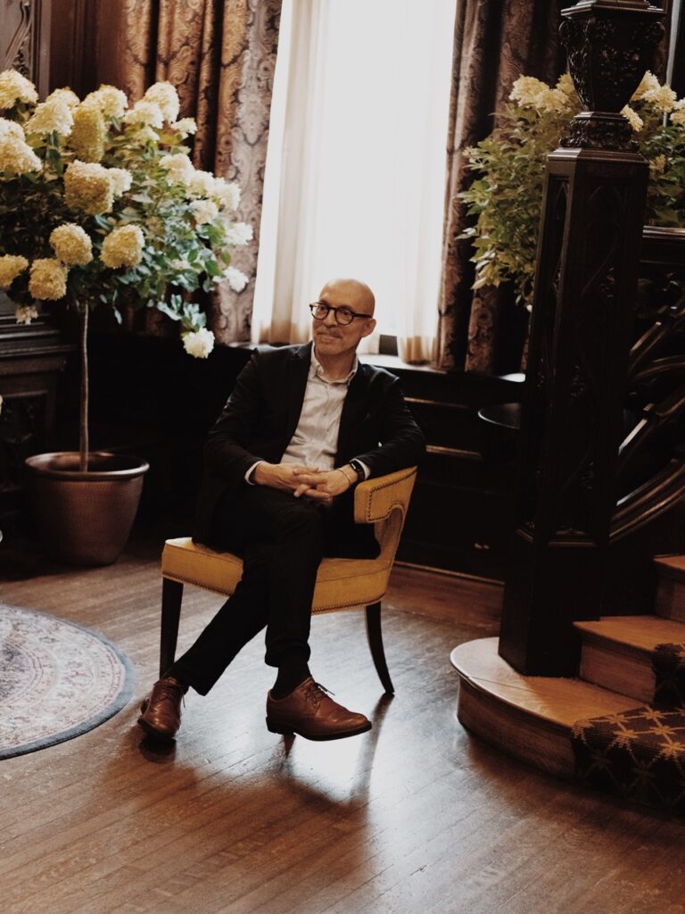 A man sits in a yellow chair.