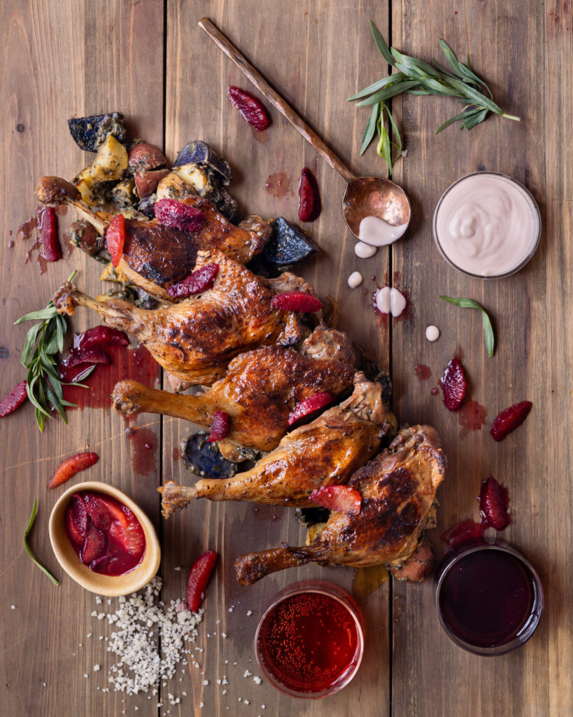 Duck legs arranged in a line with various sauces