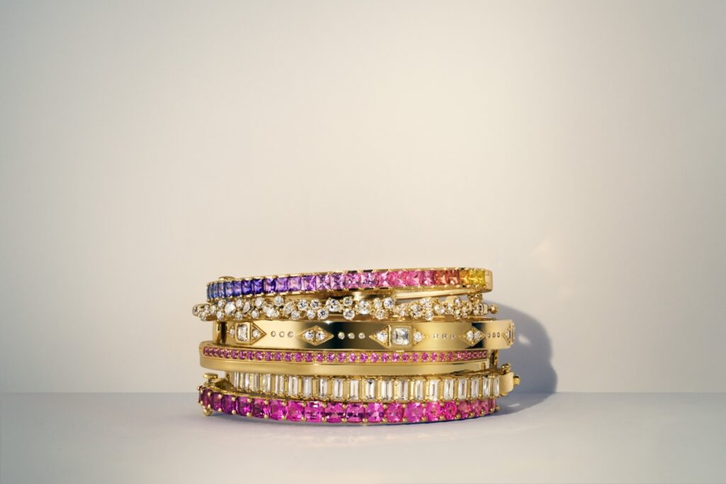 A stack of gold and pink bangles.