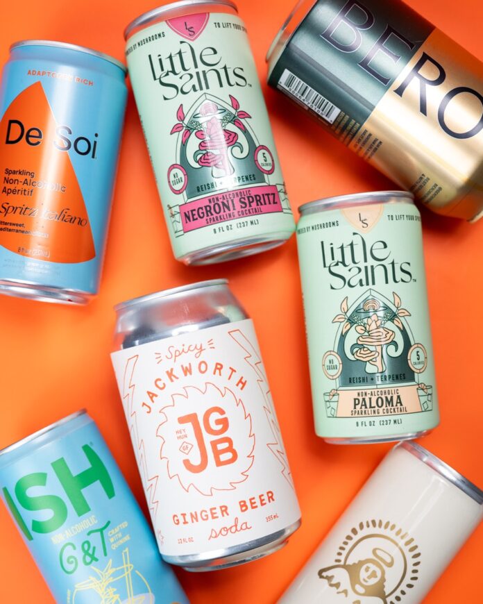 A series of non-alcoholic beverage cans from Dry January on an orange background.