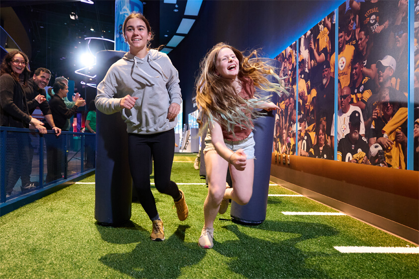 Sports360 girls running through an obstacle course