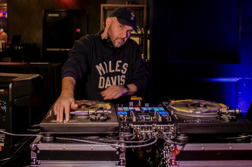 A DJ spins records on a table.