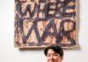 Ginger Brooks Takahashi Prepares a Multi-sensory Installation for the 59th Carnegie International Ginger Brooks Takahashi sits in a wood chair in her studio with a painting above her.