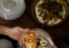 Pittsburgh Resources for Immigrant Support and Success Two hands reach for a plate of immigrant cultural cuisine ina. slaw and dumplings.
