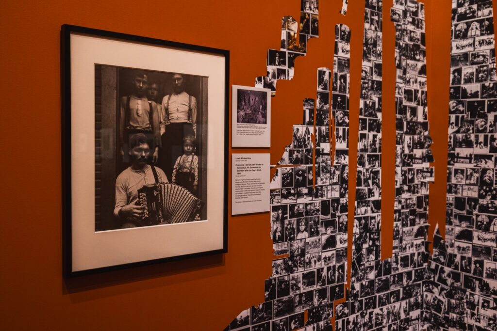 A framed photo of immigrant workers sits beside little photos in a collage.