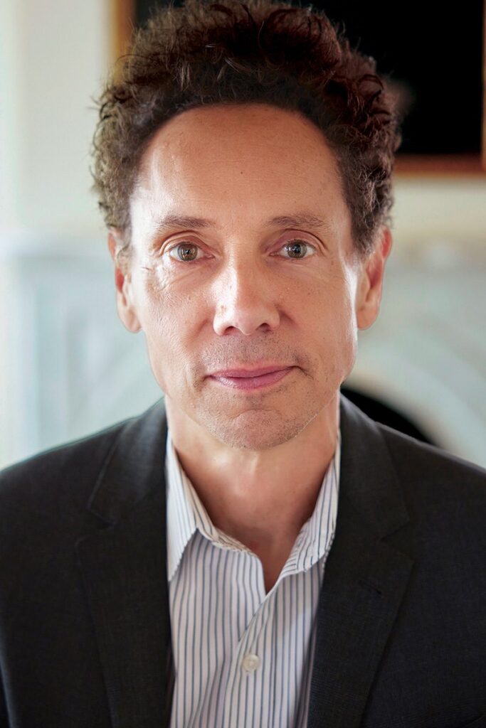 Malcolm Gladwell in a suit jacket in a portrait picture.