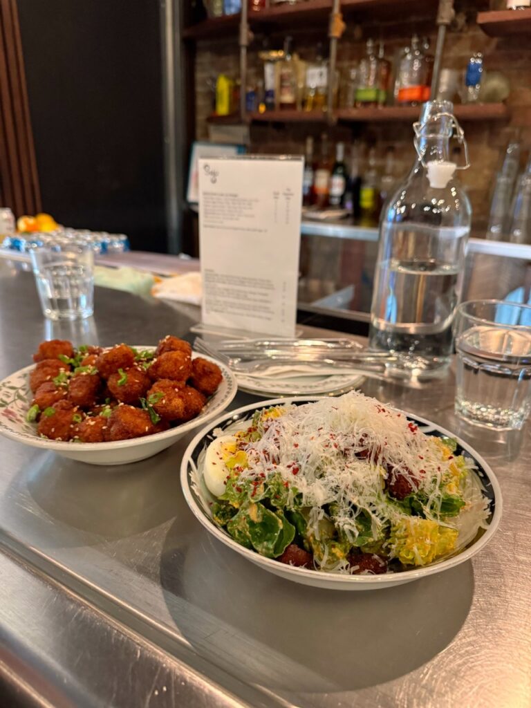 Two bowls, one full of crispy tofu, the other full of a salad.