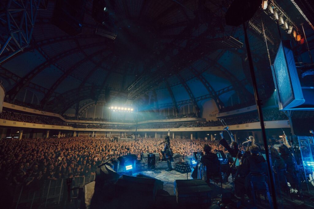 Mia Asano on stage in front of a large crowd.