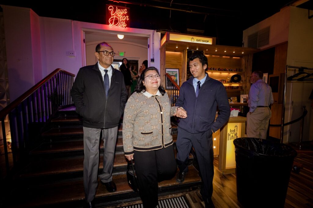 A man helps a woman walk down a staircase.