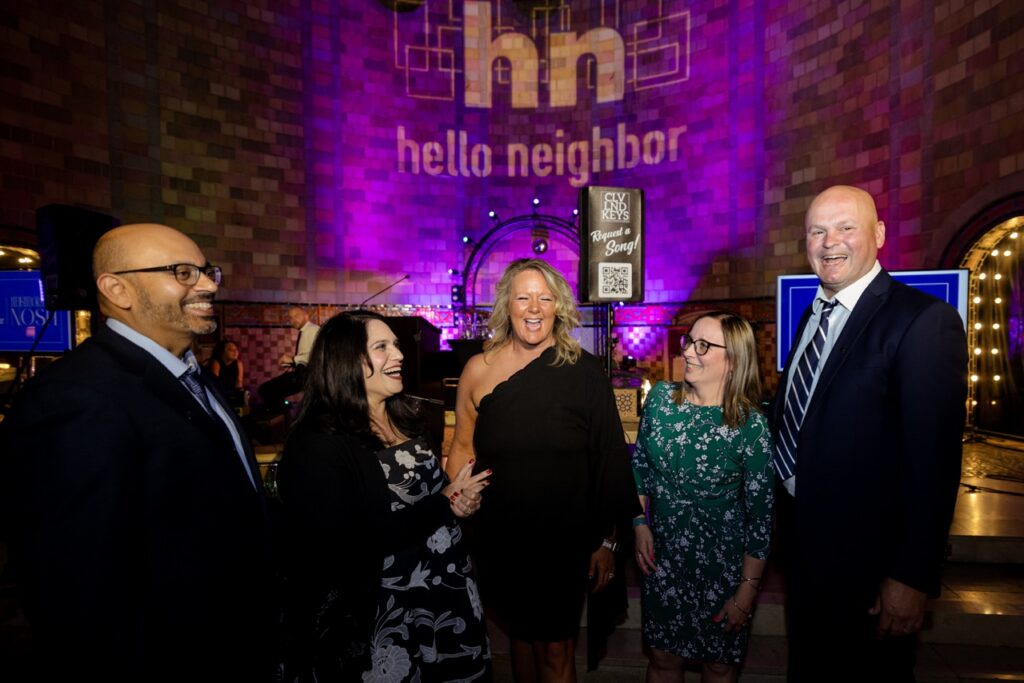 A group of women and men laugh together.