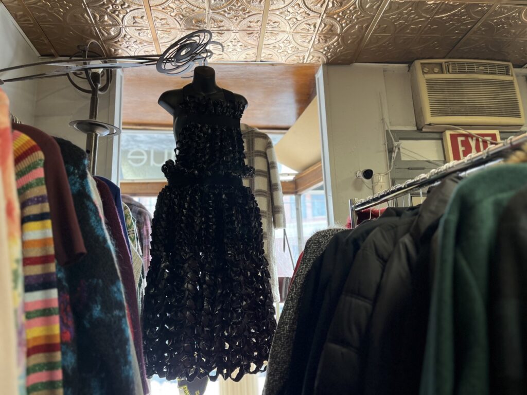 A black dress at Phoenix Boutique hangs from the ceiling.