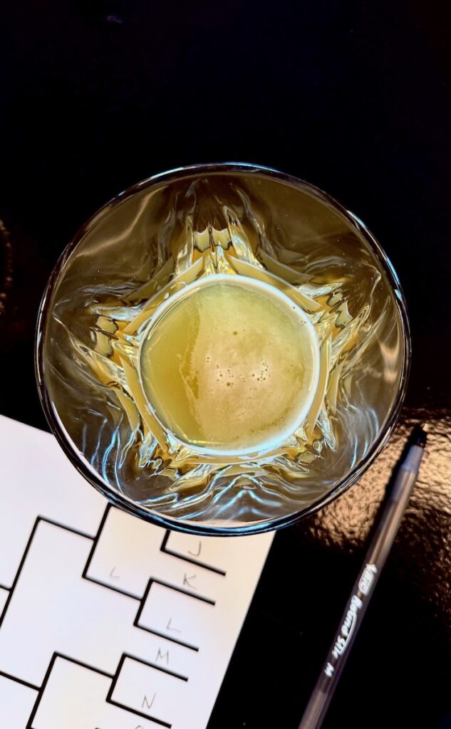 The inside of a glass of beer beside a bracket.