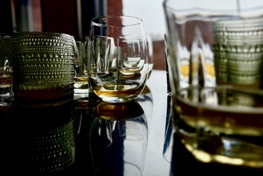 Glasses with beer in them sit on a table.