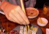 Pittsburgh Restaurant Menu Highlights from Hungry Jess: February 2026 A person uses chopsticks to grab a piece of sushi on a plate.
