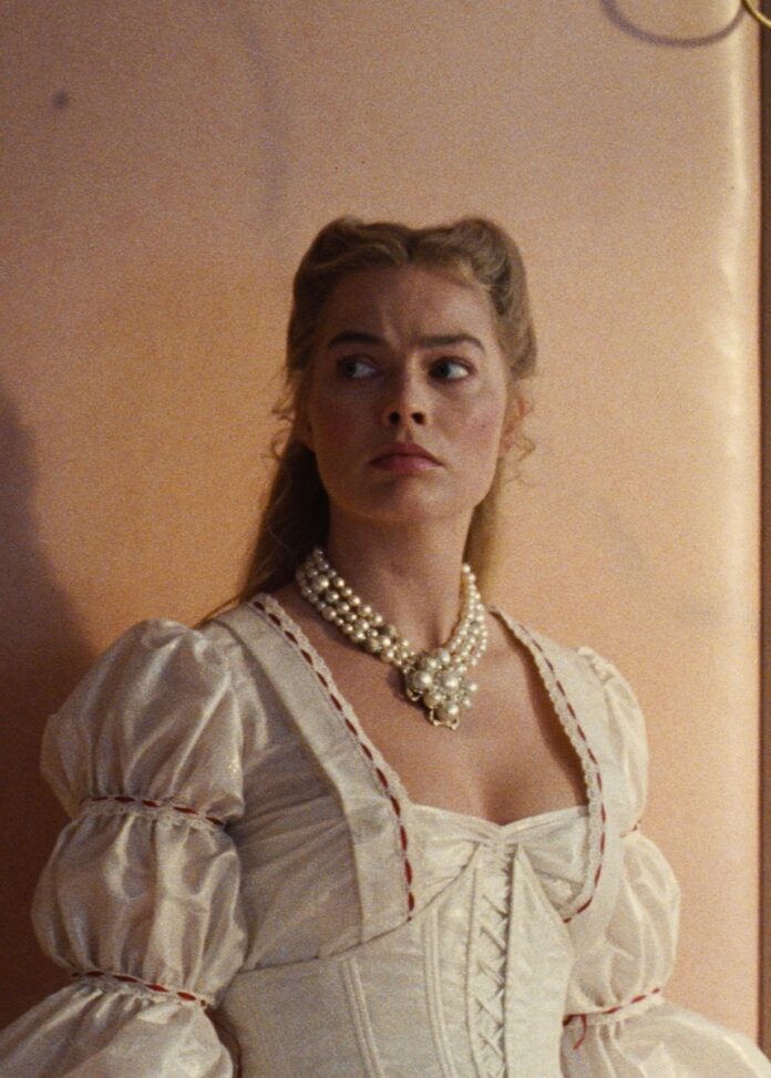 Wuthering HeightsTABLE Magazine 2 Margot Robbie in Wuthering Heights standing in a white gown.