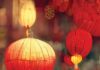 Your Astrological New Year Horoscope for Spring 2026 Paper lanterns in a red color for the New Year in China hang from the ceiling with lights inside of them.