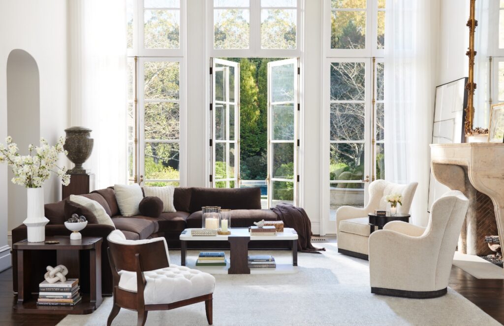 A sophisticated living room featuring the Hickory Chair Marquesa sectional with tuxedo arms and an American Ash base, accented by a chocolate and ivory color palette and 20th-century Italian design influences.