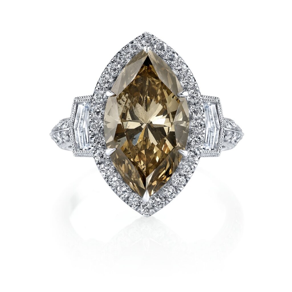 A luxury platinum ring from Louis Anthony Jewelers featuring a large, radiant-cut natural brown diamond center stone accented by two kite-shaped white diamonds.