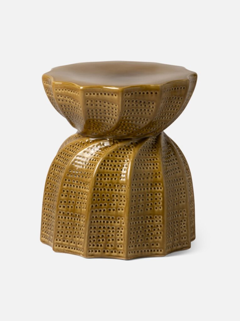The Made Goods Bea Stool in a gold-toned glazed ceramic, featuring a sculptural hourglass shape with an intricate perforated pattern for indoor or outdoor use.