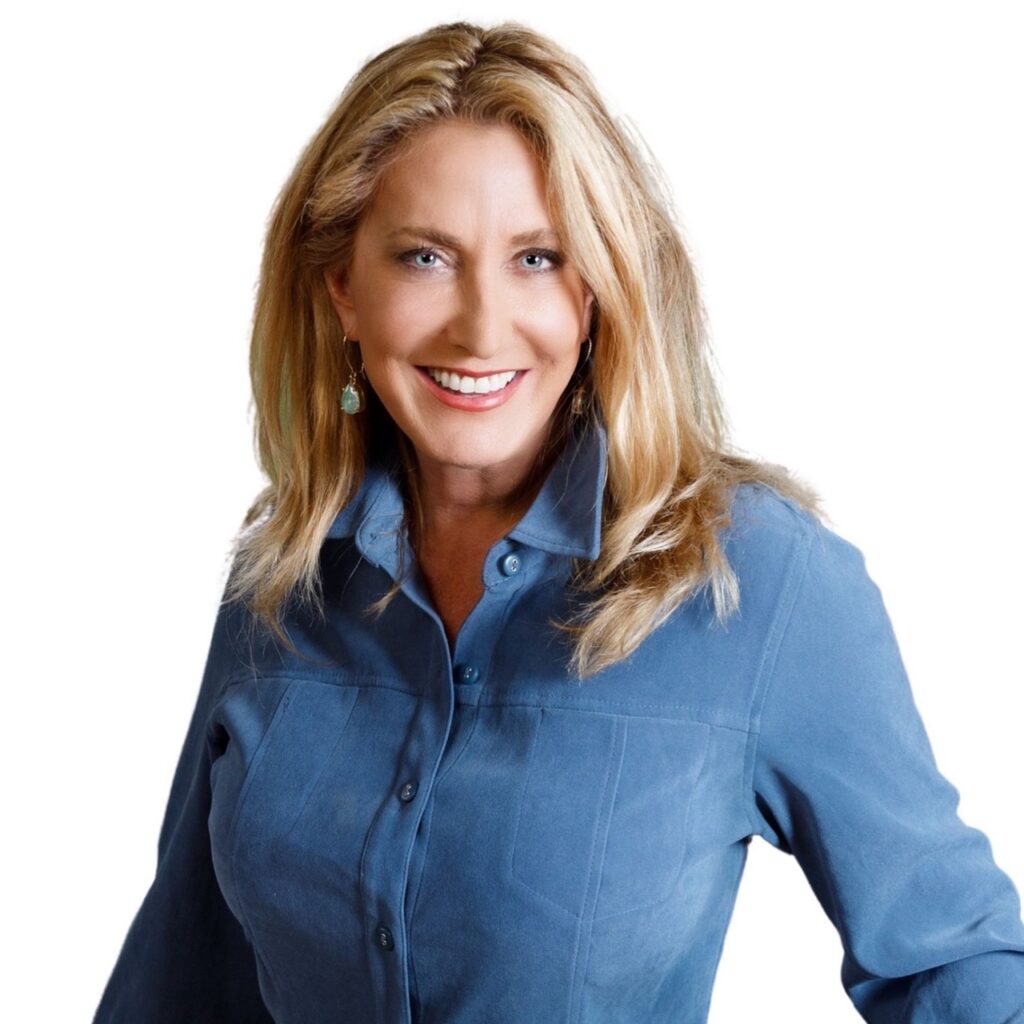 A woman in a blue shirt buttoned up with blonde hair. 