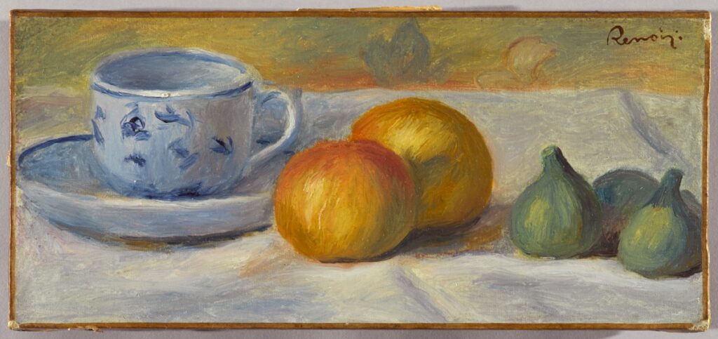 A still life oil painting by Pierre-Auguste Renoir featuring a blue and white patterned teacup on a saucer alongside two yellow peaches and three green figs on a white tablecloth.