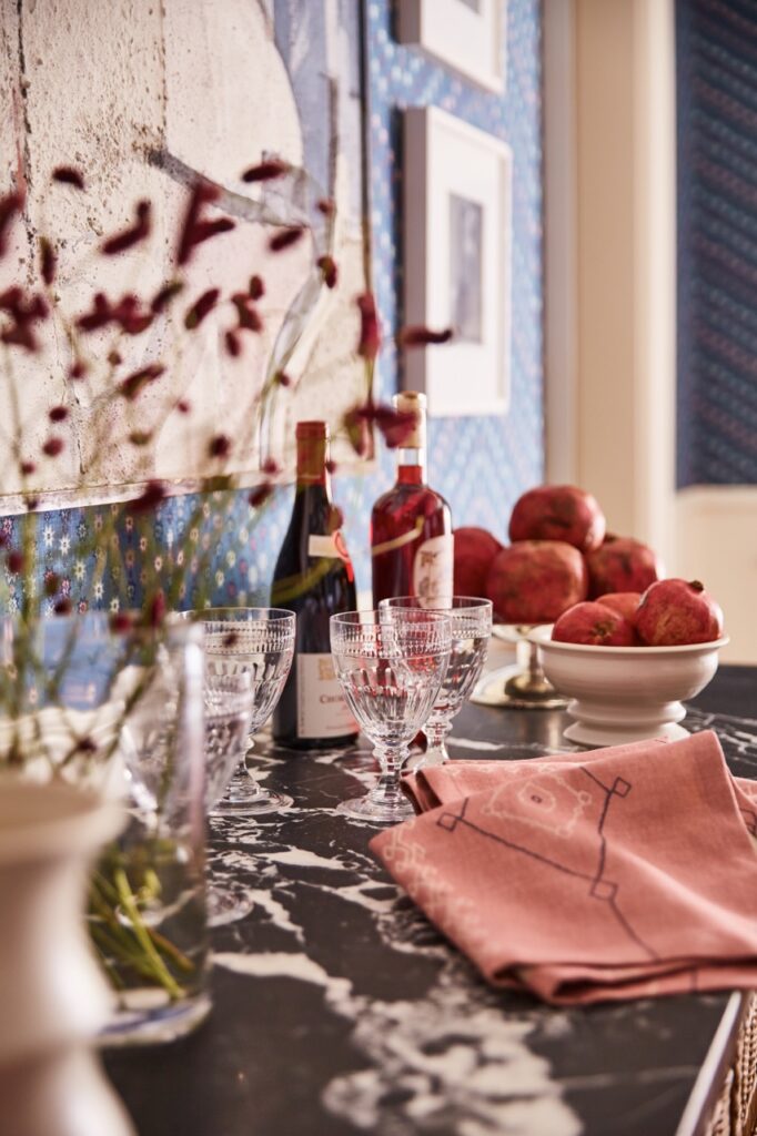 Colorful table setting with dark orange highlights in bottles and flowers.