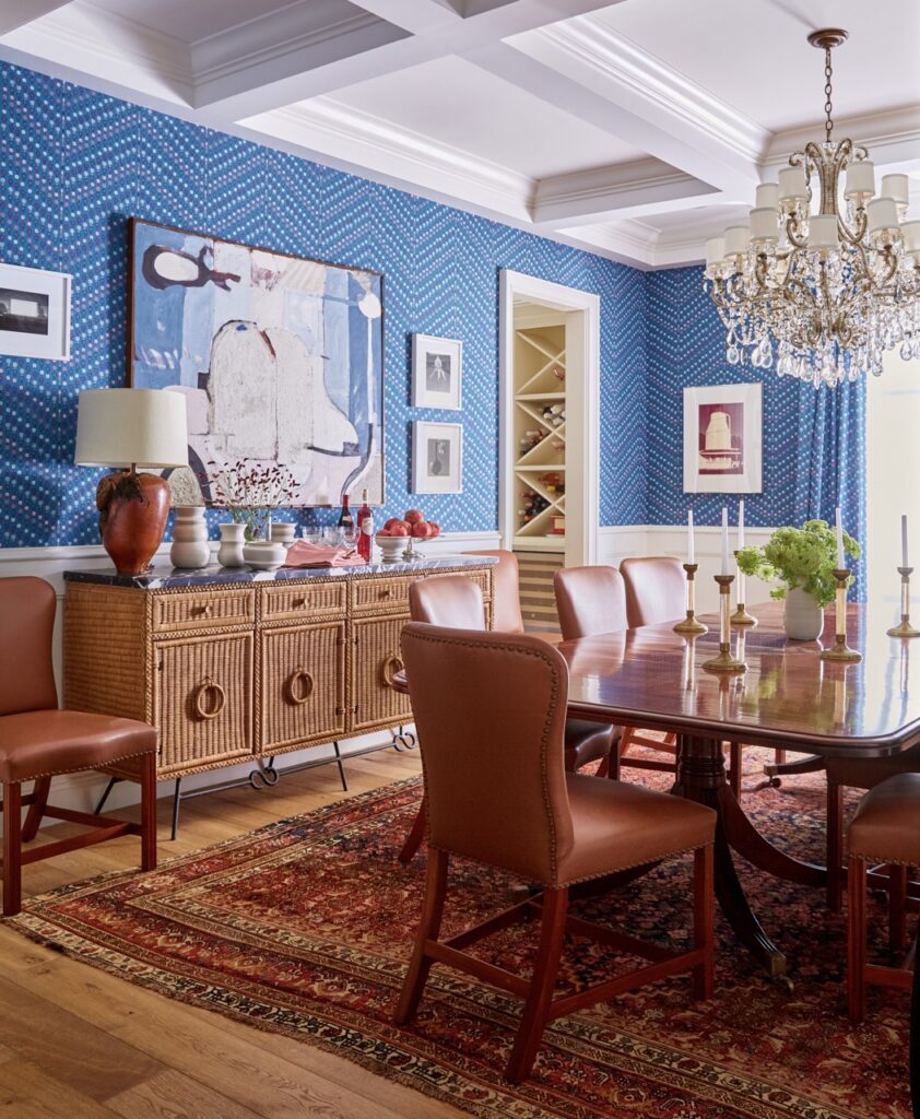 A dining room with brown chairs and blue walls.