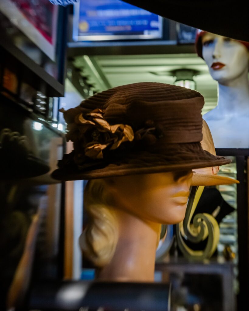 A brown vintage hat sits on a mannequin head.