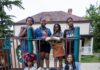 South Hills and Beyond: Pittsburgh Guide for a Relaxed Weekend A group of diverse children smiling and posing on a playground slide in front of a house in South Park, Pennsylvania.