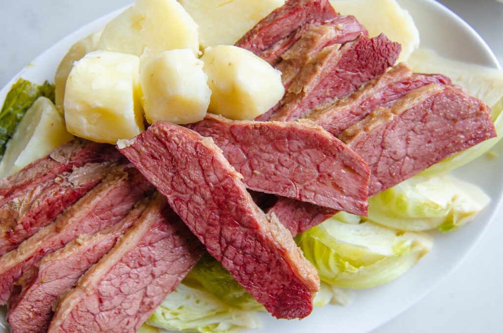 A mix of corned beer with potatoes and cabbage on a plate.