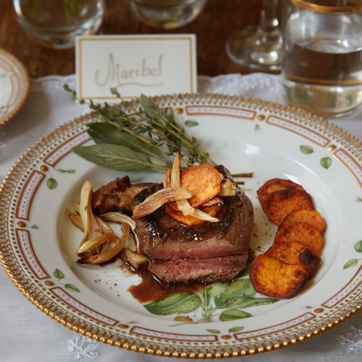 A filet mignon with mushrooms on a plate, displayed by Maribel Lieberman
