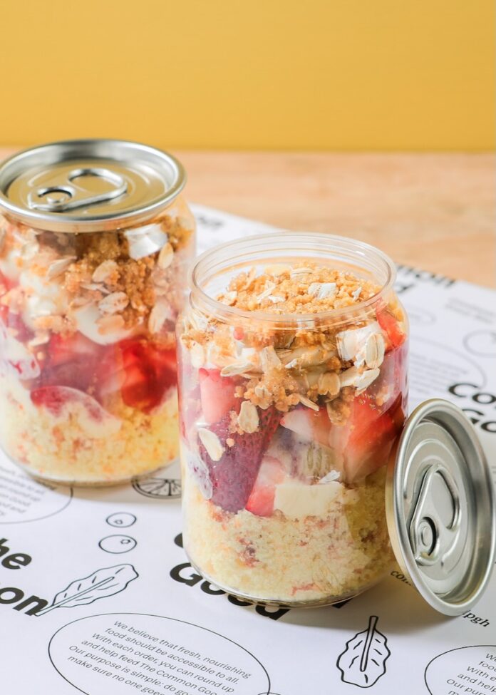 Two cans of cake sit on a table at The Common Good.