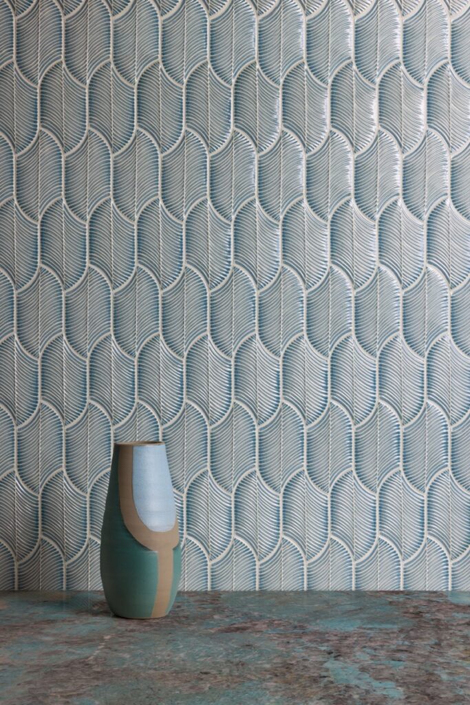 A bathroom wall featuring Frondere Aqua subway tiles in a serene blue-green hue, showcasing a handmade crackle glaze finish and a subtle three-dimensional textured surface.