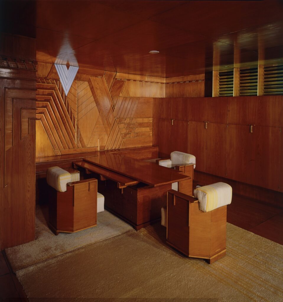 The inside of an all wood room with a table built into the wall.