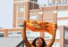 5 Events for Celebrating 412 Day in Pittsburgh Two women in Steelers shirts hold up Terrible Towels in front of Bakery Square in Pittsburgh.