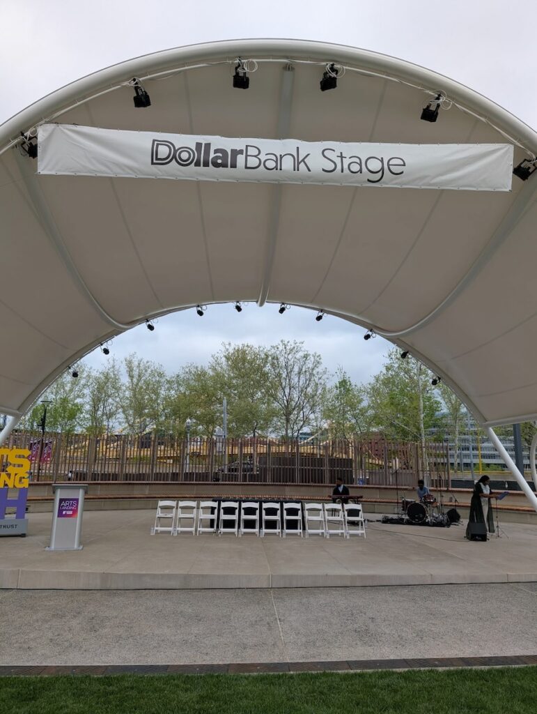 The DollarBank Stage with a row of chairs beneath the covering.