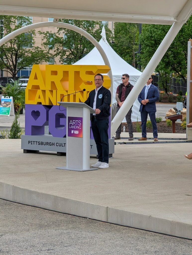 Josh Shapiro speaks in front of the Arts Landing sign.