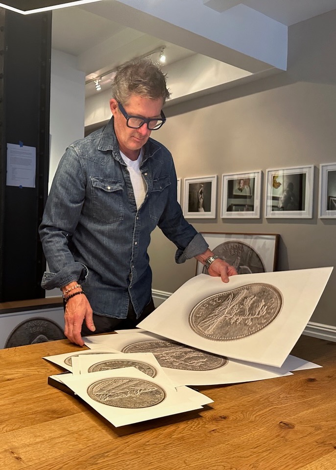 Blaise Hayward Quarters TABLE Magazine 6 Blaise Hayward looks through large prints of his state quarters series.