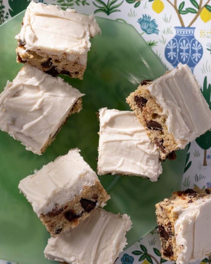 Bourbon Cookie Bars sit frosted on a green plate.