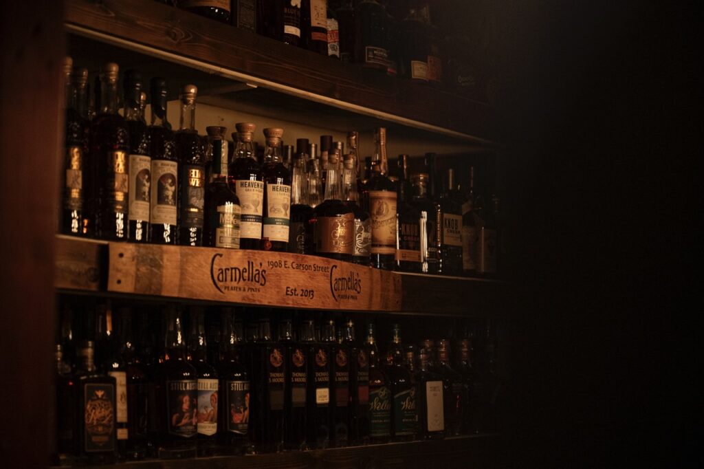 Two shelves of scotch bottles at Carmella's.